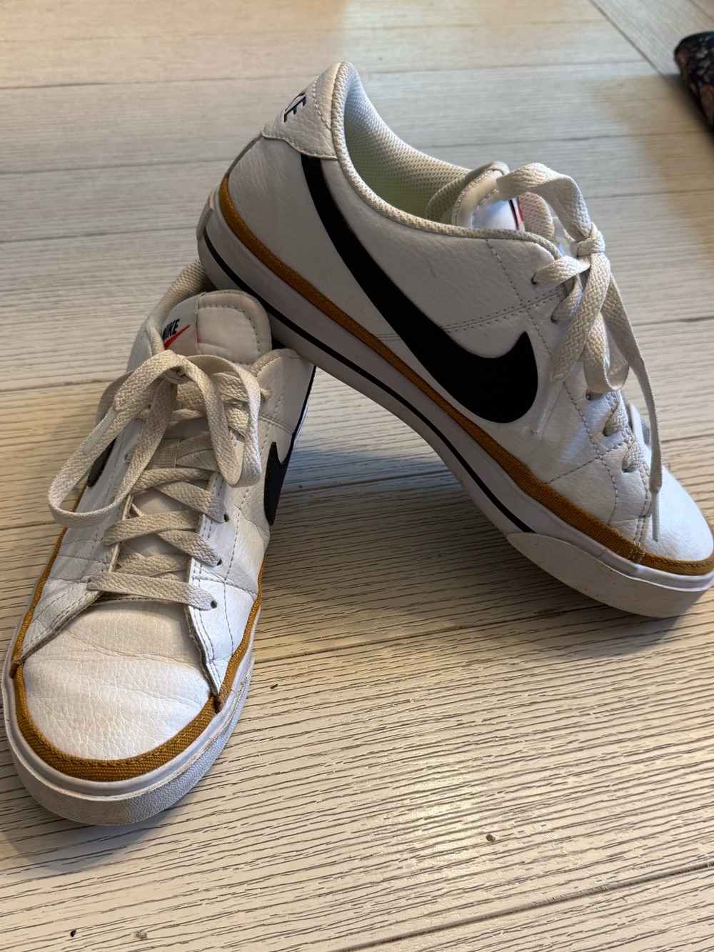 Nike White Low-Top Sneakers with Black Swoosh and Mustard Trim